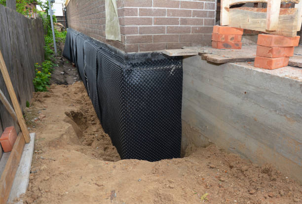 Happy homeowners after waterproofing job in Le Roy